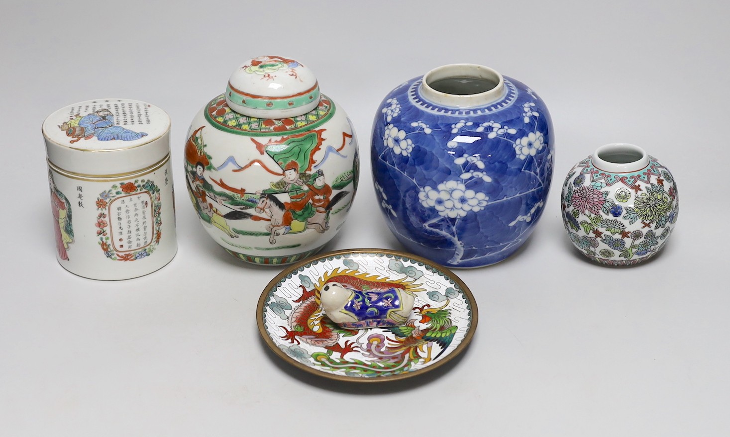 A 19th century Chinese famille rose box and cover, a blue and white prunus jar, two other jars, a figural brush rest and a cloisonne enamel dish